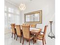 The dining room boasts marble floors, a modern chandelier, and bright natural light at 818 Golf Island Dr, Apollo Beach, FL 33572