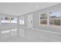 Modern living room showcasing tile floors, freshly painted walls and large windows for natural light at 8549 Oakhurst Rd, Seminole, FL 33776