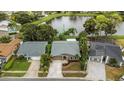 Aerial view of a single-Gathering home in a serene neighborhood near a lake at 289 Whisper Lake Rd, Palm Harbor, FL 34683