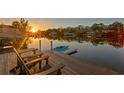 Stunning sunset view from the private dock with seating and kayak launch at 3225 Bluff Blvd, Holiday, FL 34691