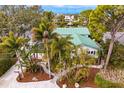 Lush landscaping and unique architecture enhance this home's curb appeal at 3225 Bluff Blvd, Holiday, FL 34691