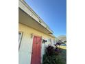 The property has a red front door framed by plants, with visible roof edge damage at 5124 Brookmeade Dr, Sarasota, FL 34232