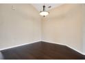 Bright living room featuring sleek dark floors and a modern light fixture at 11530 57Th Street E Cir, Parrish, FL 34219