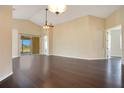 Spacious living room featuring sleek dark floors, a sliding glass door and vaulted ceilings at 11530 57Th Street E Cir, Parrish, FL 34219