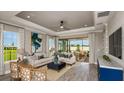 Bright living room featuring modern furnishings, neutral color palette, wood floors, recessed lighting, and backyard views at 29537 Zupetta Ln, Wesley Chapel, FL 33545