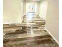 View of the open-plan living room featuring modern laminate flooring at 6391 N 68Th N Ln, Pinellas Park, FL 33781