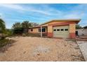 Single story home featuring a one-car garage and gravel landscaping at 2817 Miriam S St, Gulfport, FL 33711