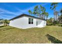 Backyard featuring new construction and a green lawn at 3083 Sikeston Ave, North Port, FL 34286