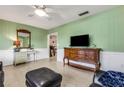 Inviting living room featuring light green walls, ceiling fan and stylish furnishings at 3084 Williamsburg St, Sarasota, FL 34231