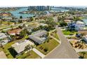 Beautiful aerial view of a neighborhood with waterfront homes near a large bay and modern condos at 10111 Yacht Club Dr, Treasure Island, FL 33706