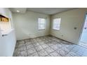 Bright, open-plan living area with tiled flooring, offering plenty of natural light from dual windows at 7120 Waterside Dr # 106, Tampa, FL 33617