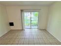 Bright living room with tile flooring and sliding glass doors to the outside at 7177 E Bank Dr # 102, Tampa, FL 33617