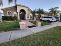 Charming home featuring arched windows, a welcoming entrance, and a three car garage at 10327 Meadow Crossing Dr, Tampa, FL 33647