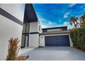 Stylish two-story home showcasing a unique window design and a two-car garage at 4760 Meredith Ln, Sarasota, FL 34241