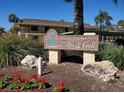 Villas de Golf community sign with landscaping and partial view of building in background at 12300 Vonn Rd # 7203, Largo, FL 33774