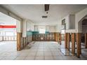 Open kitchen space featuring white cabinets, a window, and tile flooring at 7840 Gulf Way, Hudson, FL 34667