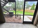 Cozy screened patio with a view of the lush green lawn, offering a serene outdoor space for relaxation at 4034 Dream Oak Pl # 104, Tampa, FL 33613