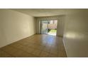 Bright living room with tile flooring and sliding glass doors to the exterior at 7502 Needle Leaf Pl # B66, Tampa, FL 33617