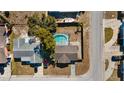 Aerial view of the house showcasing the pool, nearby street, and the surrounding neighborhood at 8012 Durham Dr, Port Richey, FL 34668