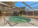 Screened pool with a metal ladder, providing a secure and enjoyable outdoor recreation space at 8012 Durham Dr, Port Richey, FL 34668