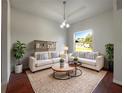 Bright living room features hardwood floors, neutral paint, and two sofas surrounding a modern round table at 3328 Circleville St, North Port, FL 34286