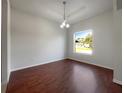 The living room has cherry-wood floors and a large window for lots of light at 3328 Circleville St, North Port, FL 34286