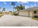 Spacious two-car garage with a wide driveway and convenient side entry door at 26058 Paysandu Dr, Punta Gorda, FL 33983