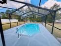 Sparkling pool with a screened enclosure offers a private oasis for relaxation and enjoyment at 9151 Bay Dr, Spring Hill, FL 34606
