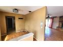 An entryway featuring laminate floors, a built-in shelf, and an open view to an adjacent living room at 5109 19Th W St, Bradenton, FL 34207