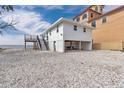 Charming raised beach house featuring stairs to a deck with ocean view and ground level covered parking at 6417 Driftwood Dr, Hudson, FL 34667