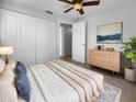 Bright bedroom with large closet, ceiling fan, and dresser with modern art above at 913 27Th E St, Bradenton, FL 34208