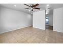 Neutral-toned empty room with tile floors and ceiling fan ready for personalization at 913 27Th E St, Bradenton, FL 34208