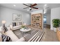 Bright living room with stylish striped rug, modern furniture, and built-in bookshelf at 913 27Th E St, Bradenton, FL 34208