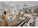 Bright living room with light wood floors, stylish furnishings, and sliding glass doors to the patio at 4903 Rambling Rose Pl, Tampa, FL 33624