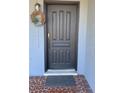 Close-up of a front door featuring a dark finish, traditional panel design, and welcoming wreath at 814 20Th Sw St, Largo, FL 33770