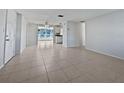 Bright open concept living room with tile flooring, seamlessly flowing into the dining area at 507 Circlewood Dr # O2, Venice, FL 34293