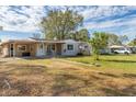 Single-story home featuring a covered front porch and driveway with a neatly landscaped yard at 5350 47Th N Ave, St Petersburg, FL 33709