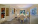 Bright dining area featuring sliding glass doors to the backyard and wood-look floors at 10917 Brickside Ct, Riverview, FL 33579