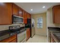 Well-equipped kitchen with stainless steel appliances and granite countertops at 10917 Brickside Ct, Riverview, FL 33579