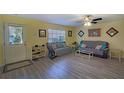 Inviting living room with neutral paint, ceiling fan, and laminate flooring at 10917 Brickside Ct, Riverview, FL 33579