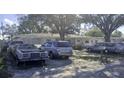A view of the front of the house, showing the cars parked in the driveway at 1814 Elk Ave, Sarasota, FL 34235