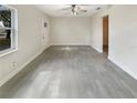 Spacious living room featuring new flooring, neutral walls, and a ceiling fan, ready for personalization at 2117 W Paris St, Tampa, FL 33604