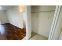 Bedroom closet with shelf and rod, tile floor, and view into a brightly lit room at 2850 Somerset Park Dr # 201, Tampa, FL 33613
