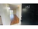 Condominium entryway leads into a brightly lit living area with wood-look flooring at 2850 Somerset Park Dr # 201, Tampa, FL 33613