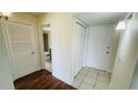 Hallway with tile flooring and a view into the bathroom showcasing the toilet and vanity at 2850 Somerset Park Dr # 201, Tampa, FL 33613