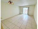 Bright living room with tile floors and sliding glass doors to outdoor area at 2856 Somerset Park Dr # 102, Tampa, FL 33613