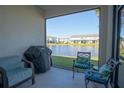 Relaxing screened-in patio area with outdoor seating, a grill, and scenic views of the lake at 363 Surfside Ne Ave, St Petersburg, FL 33716