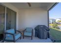 Comfortable patio seating arrangement with a view of the serene backyard pond and landscaping at 363 Surfside Ne Ave, St Petersburg, FL 33716