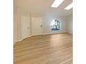 Bright and airy living room with lots of natural light, skylights, and hardwood flooring at 1038 Rolling Oaks Ave, Tarpon Springs, FL 34689