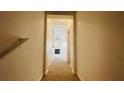 Hallway leading to a living room with a fireplace and a ceiling fan at 10519 Villa View Cir # 10519, Tampa, FL 33647